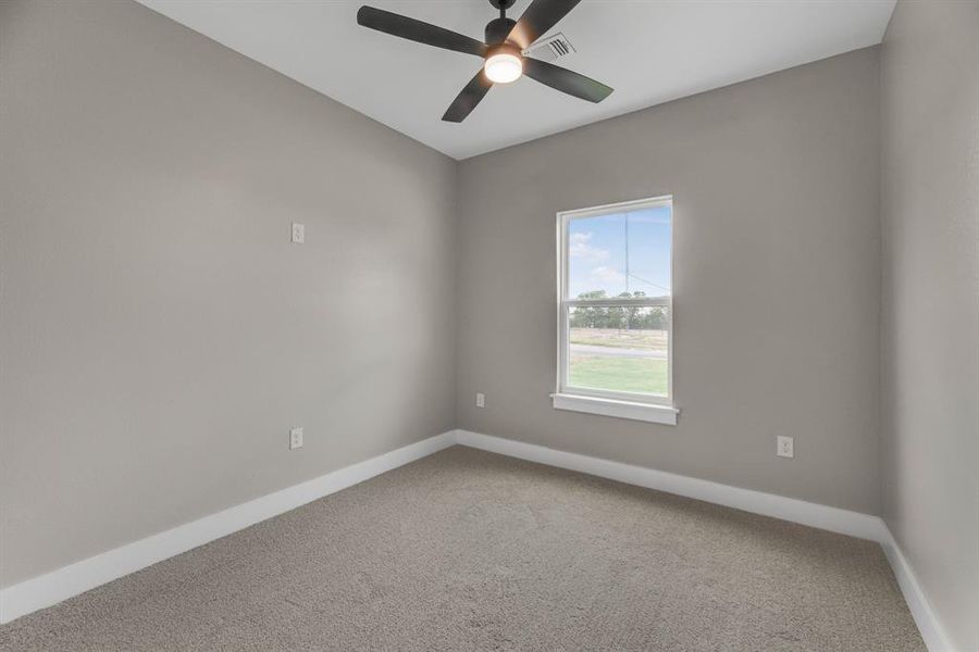 Spare room with carpet flooring and ceiling fan