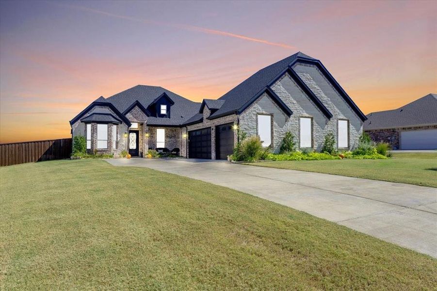 French country style house with a yard and a garage