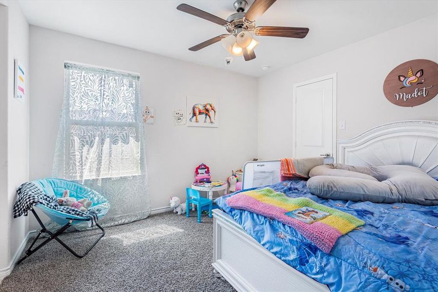 Bedroom featuring ceiling fan and carpet floors