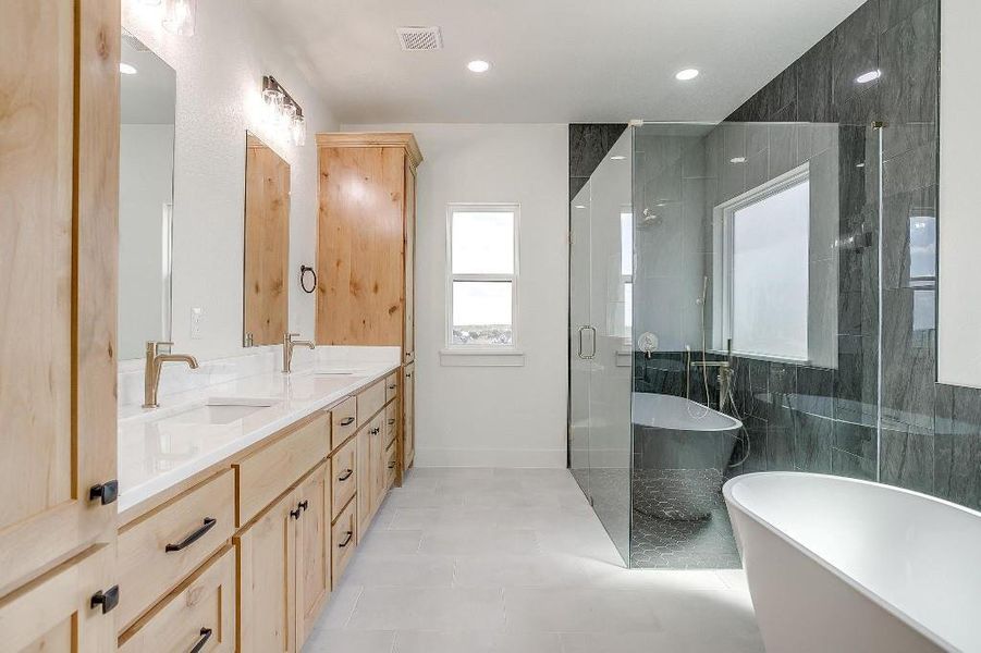 Bathroom with tile walls, vanity, tile patterned floors, and independent shower and bath