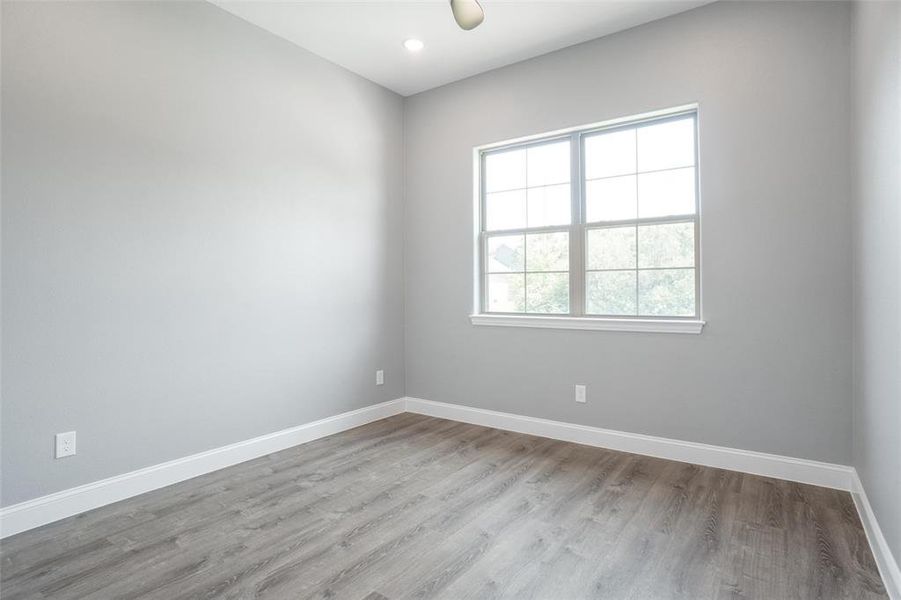 Empty room with hardwood / wood-style floors