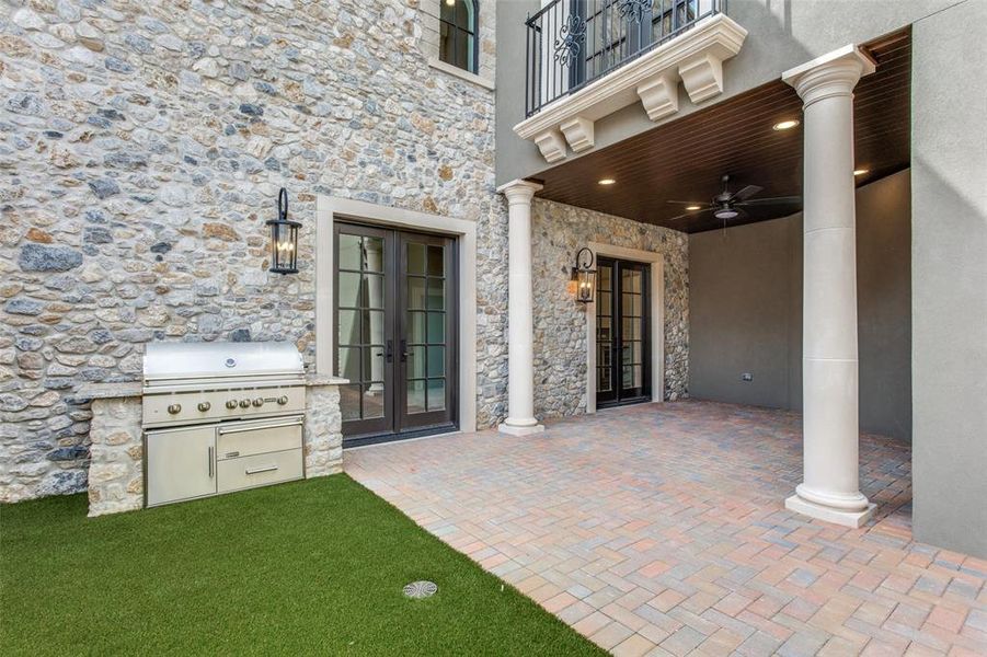 View of patio with french doors, exterior kitchen, grilling area, a balcony, and ceiling fan