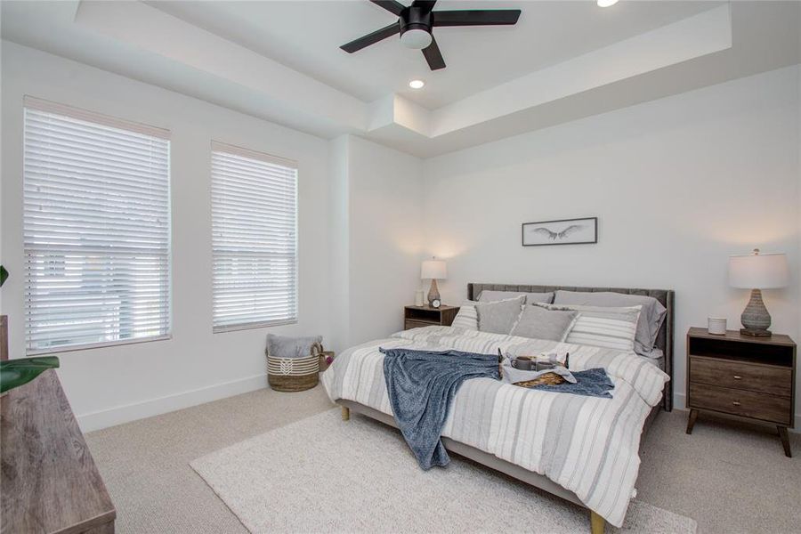 Elegant Primary Bedroom located on the 2nd floor. The high ceilings, with recessed lighting, are prewired and blocked for ceiling fans (not included). Model home photos - FINISHES AND LAYOUT MAY VARY!