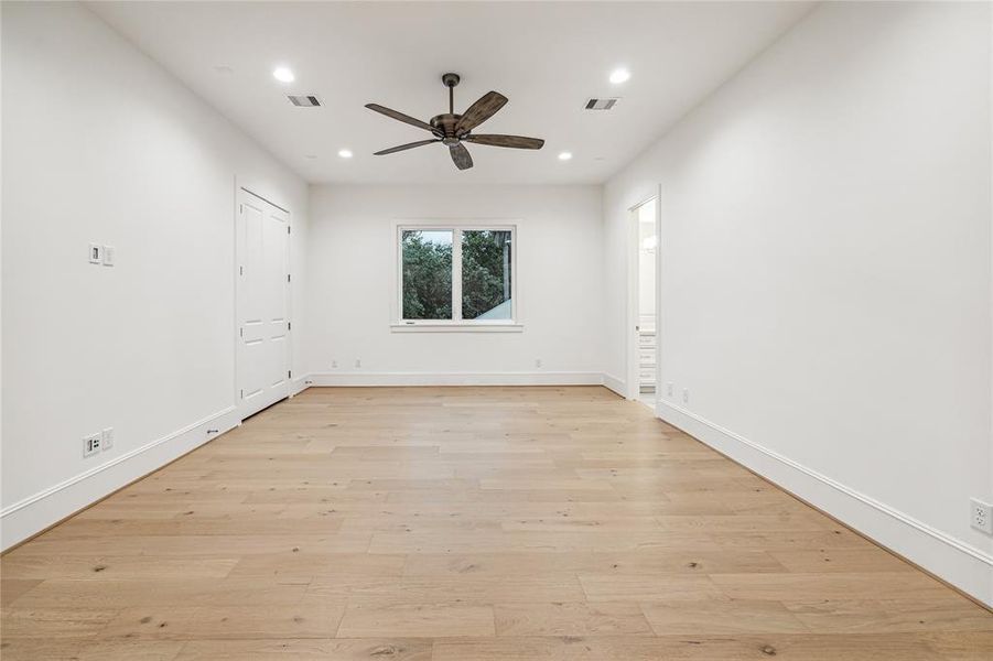 Upstairs Den, Game Room or a 4th Bedroom with 7 Inch European White Oak Planks. There is a Conduit on the wall for a TV and a Ceiling Fan. This Room is also Pre-Wired for Home Theatre (5 Speaker Locations and 1 Sub-Woofer). There is a storage closet with double doors, access to a full-bath and solid french doors.