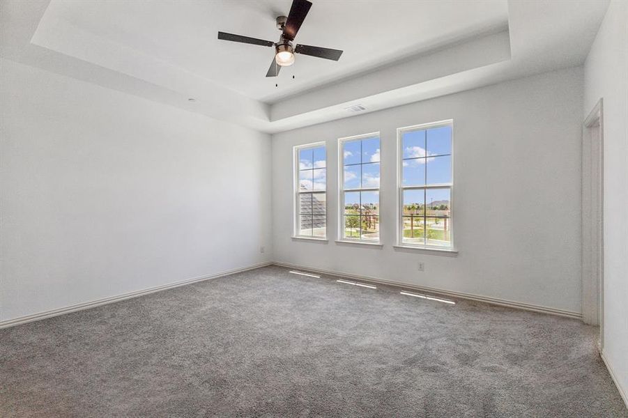 This dreamy owner's suite features a wall of windows to flood the room with natural light.