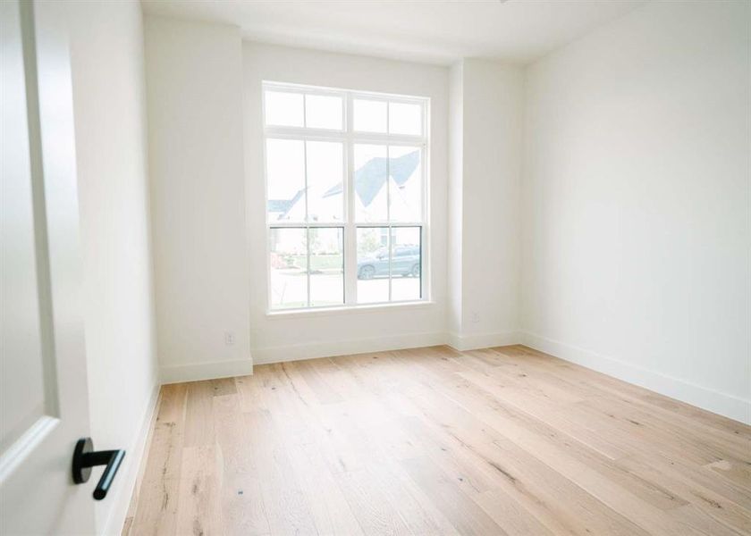 Unfurnished room with a healthy amount of sunlight and light hardwood / wood-style flooring