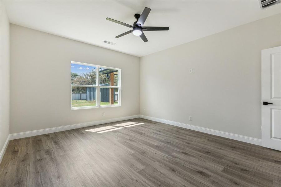 Spare room featuring ceiling fan and hardwood / wood-style floors