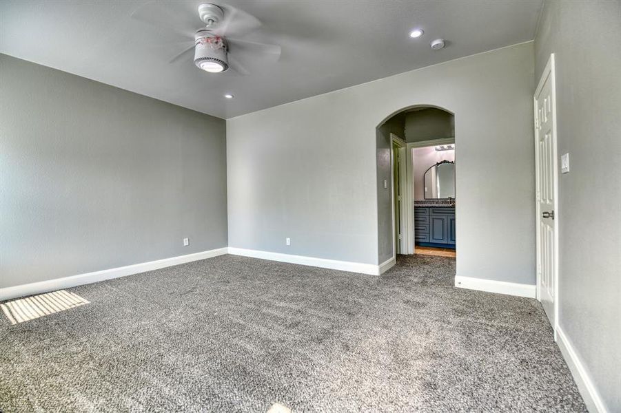 Spare room with carpet flooring and ceiling fan