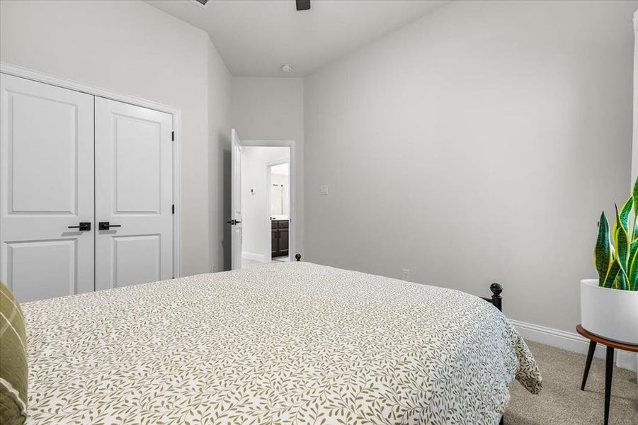 Carpeted bedroom with a closet