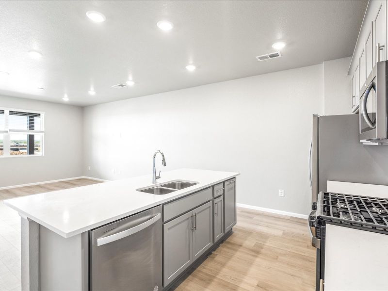 Kitchen in the Orchard floorplan at a Meritage Homes community in Aurora, CO.