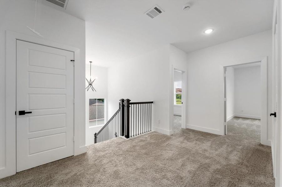 The landing upstairs lets in plenty of natural light and a storage closet is pictured on the left.