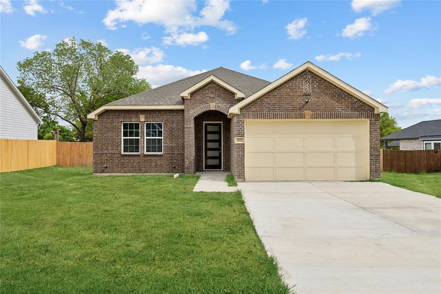 View of front of house with a garage and a front yard