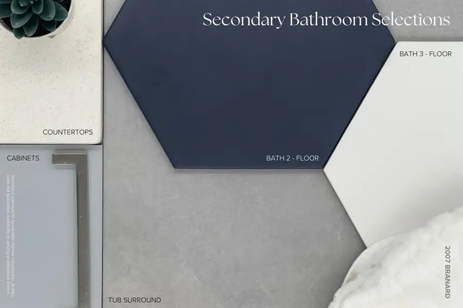 In the secondary bathrooms, cool and fresh vibes emerge as cabinets in Sherwin Williams "Online" and rich grey ceramic tile tub surrounds are paired with fun, large geometric floor tiles in crisp white and navy hues.