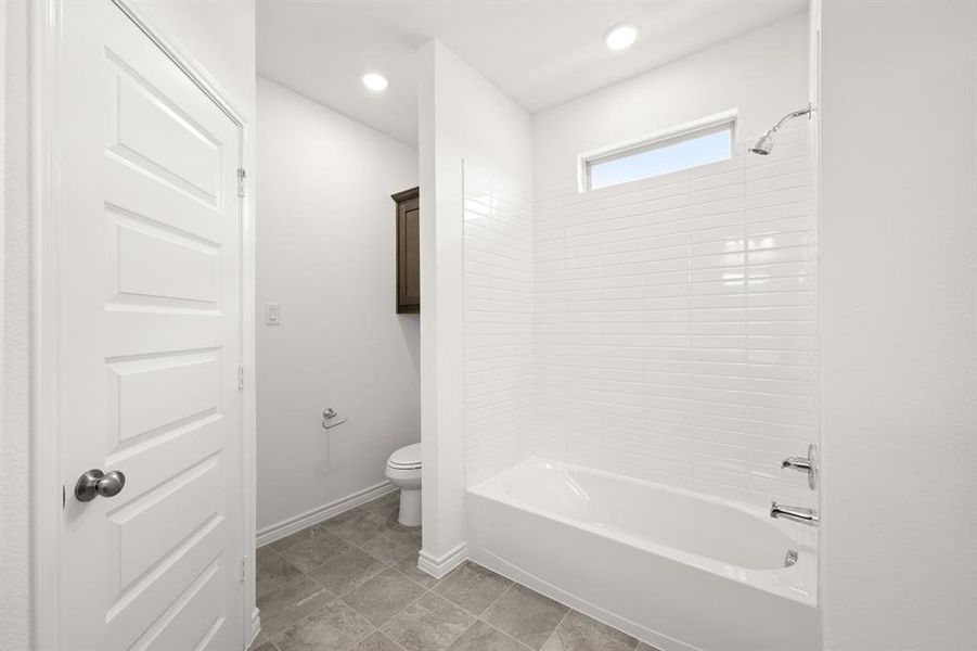 Bathroom with toilet and tub / shower combination