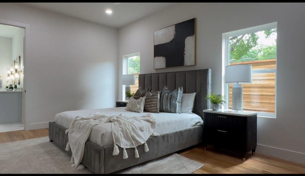 Bedroom featuring multiple windows and light wood-type flooring