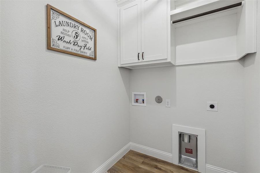 Washroom featuring cabinets, wood-type flooring, electric dryer hookup, and washer hookup