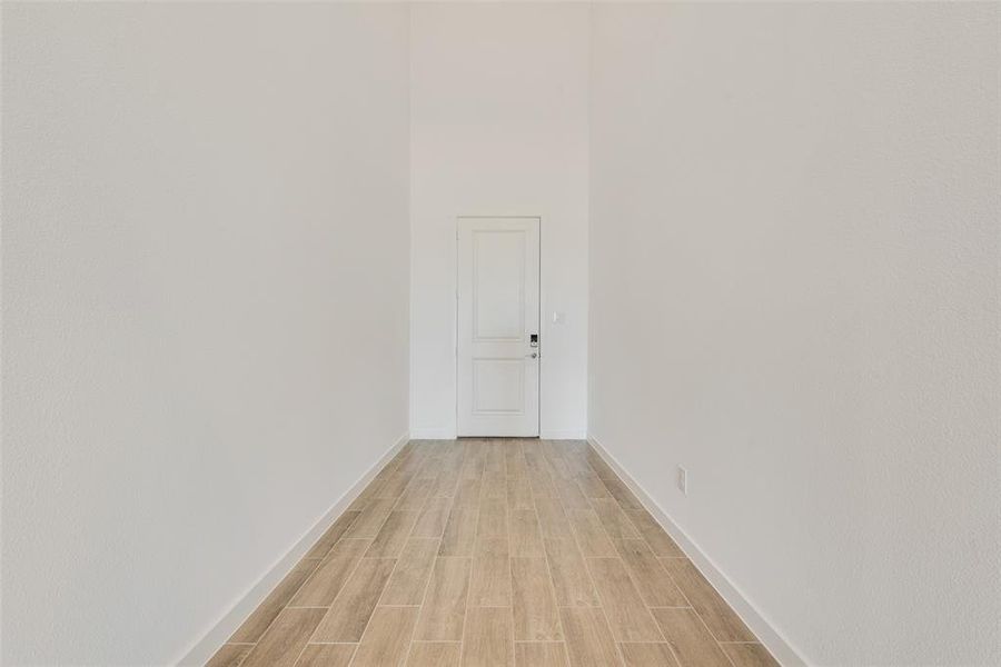 Corridor with light wood-type flooring