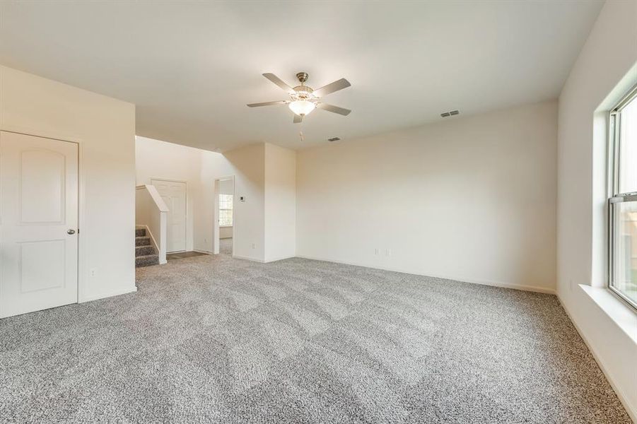 Living room with carpet and ceiling fan