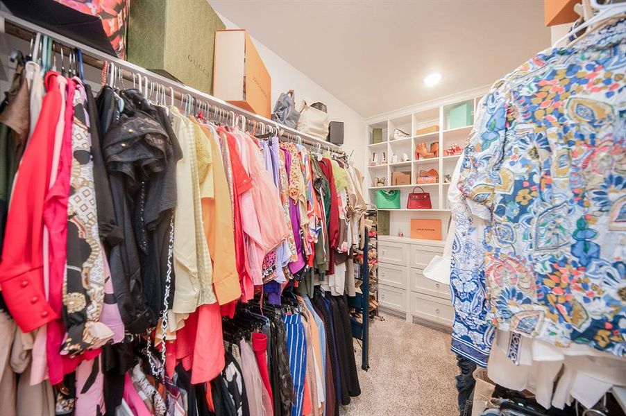 The seller completed re-did the boring builder grade closet that came with the house.  A skilled carpenter was hired to create this lovely dressing room/closet.  There are built in drawers (with beautiful crystal knobs!) & shelves, shoe cubbies, and upper & lower hanging racks.