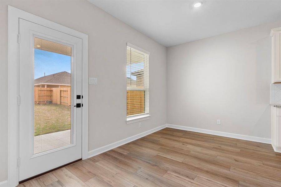 The combined dining room / kitchen overlooks the covered patio and backyard.