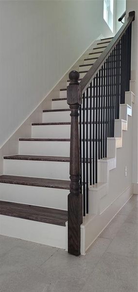 4209 Tampico St.Wooden stair rails with wrought iron spindles and a waterproof vinyl flooring.