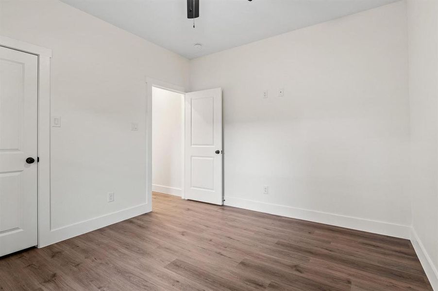 Unfurnished room with light hardwood / wood-style flooring and ceiling fan