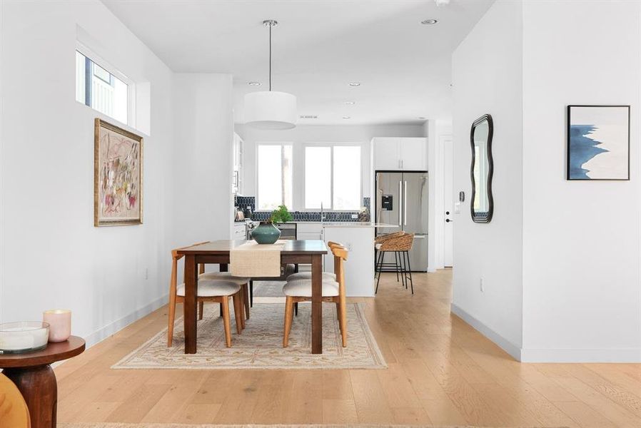 Open dining space with room for entertaining, highlighted by minimalist design and bright ambiance.