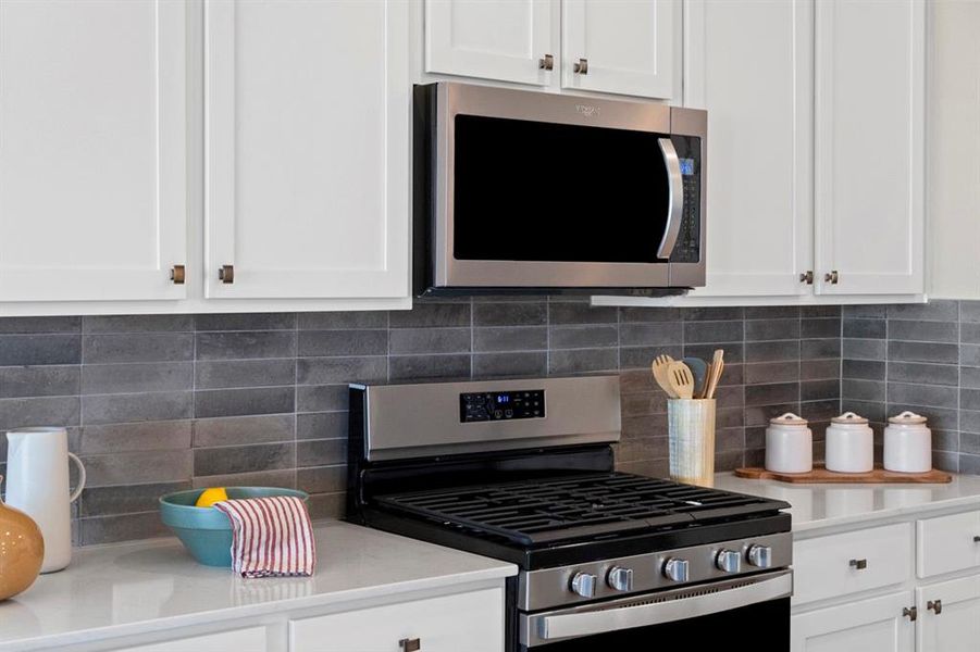 Kitchen features Stainless Steel Whirlpool appliances. This Range is a Whirlpool Gas 5-in-1 Air Fryer Oven with Fan Convection, Frozen Bake - Fingerprint Resistant Stainless Steel. The Whirlpool Microwave/Hood Combo is 3 speed, steam and sensor cooking and also Fingerprint Resistant Stainless Steel.