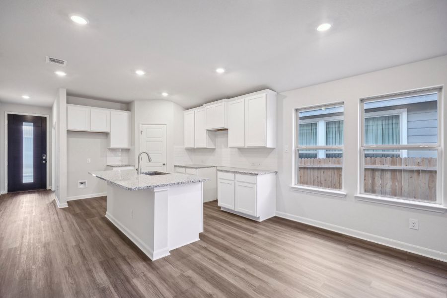 Kitchen and dining room in the Allen floorplan at a Meritage Homes community.