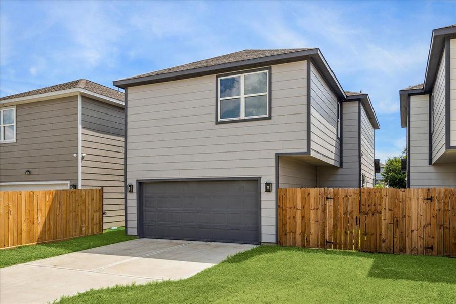 Rear loading oversized 2 car garage with long driveway for extra parking.