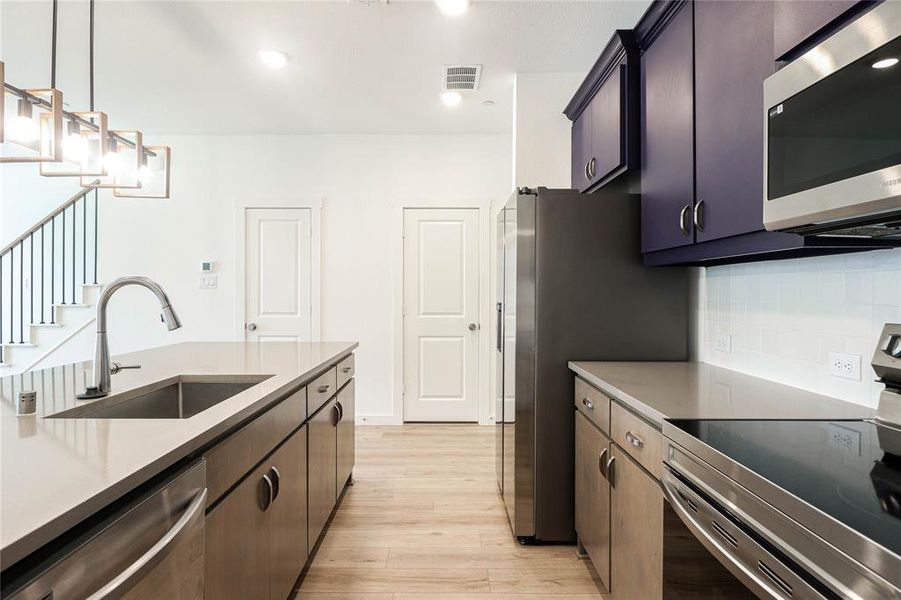 Gourmet kitchen with quartz countertops and stainless steel appliances