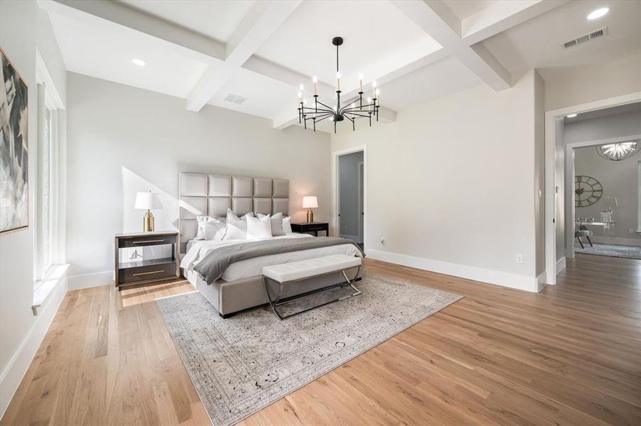 Bedroom with coffered ceiling, a notable chandelier, beamed ceiling, and light wood-type flooring