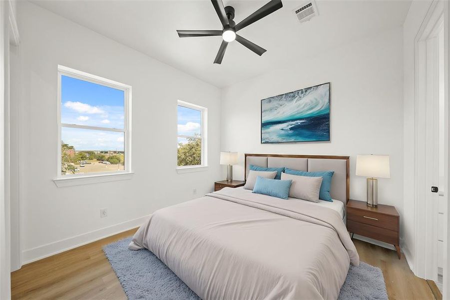 Virtually Staged: Secondary Bedroom with luxury vinyl plank floors, large windows, a ceiling fan, and a functional walk-in closet along with an en-suite bathroom.