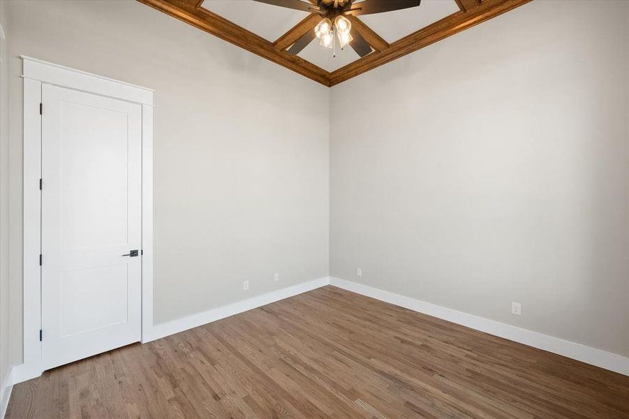 Empty room with ceiling fan and wood-type flooring