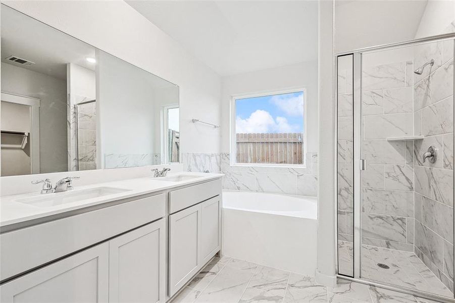 Bathroom with independent shower and bath, tile patterned flooring, and double sink vanity