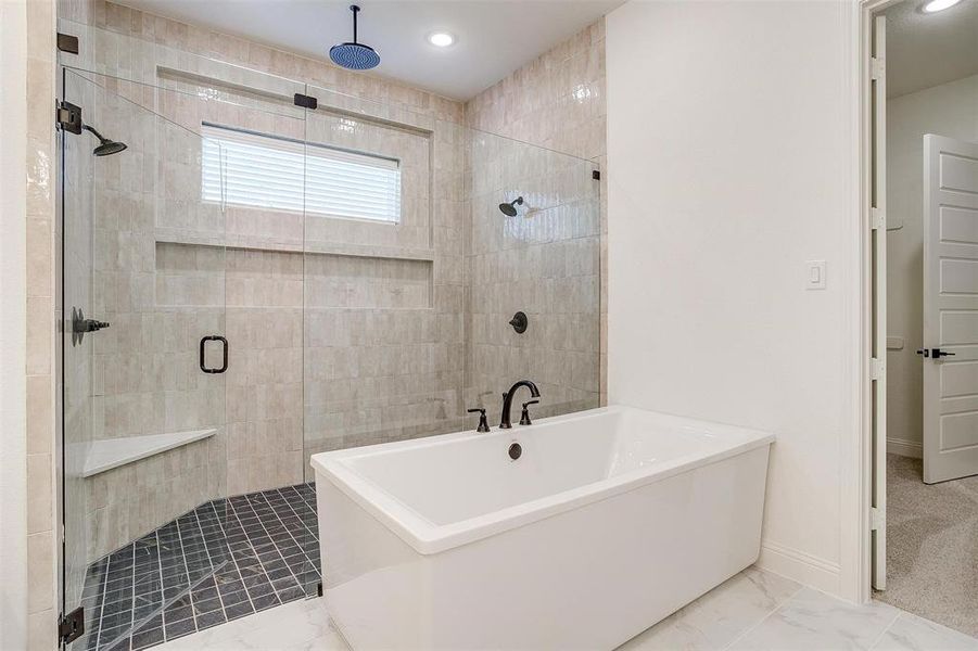 Bathroom with tile patterned flooring and independent shower and bath