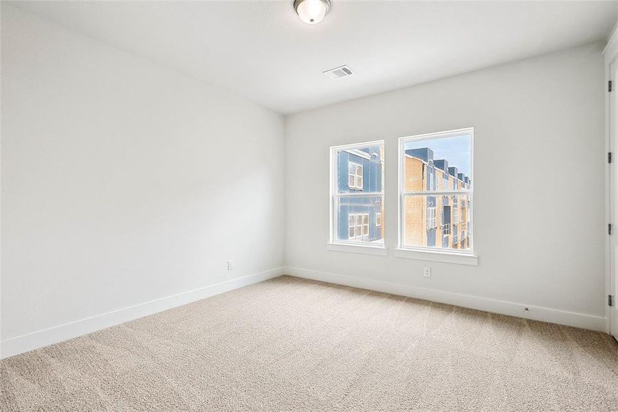 Spare room featuring light colored carpet