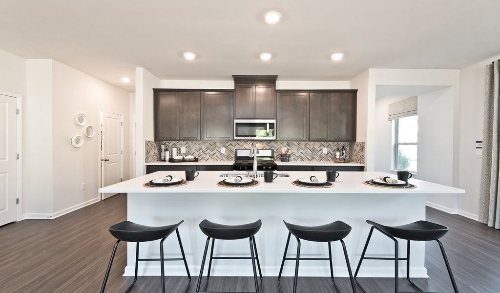 The spacious kitchen island overlooks the dining area and great room.