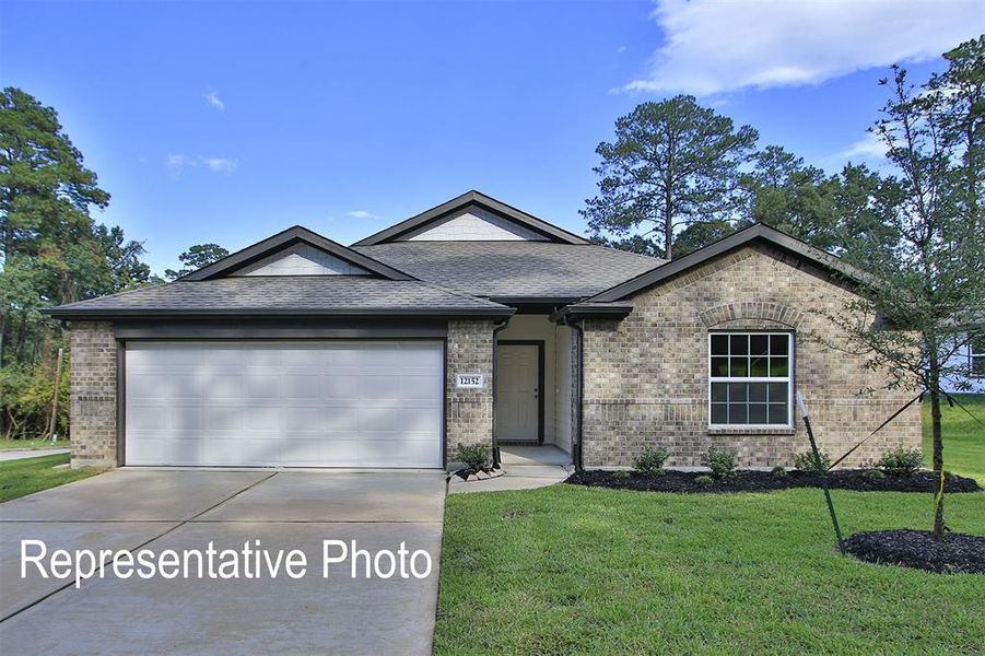 View of front of property with a garage and a front lawn