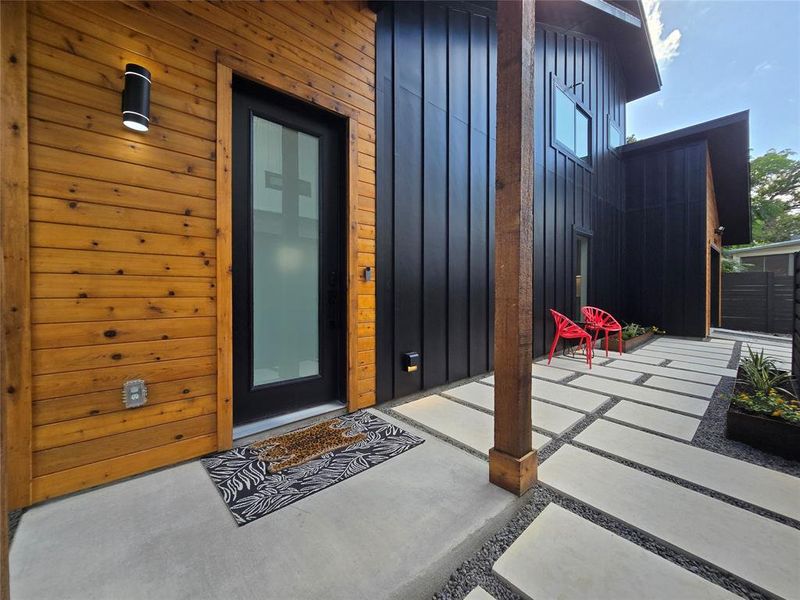 Front covered entry porch. Light by the door is a smart Wi-Fi controllable light (change color, set timing to turn on, etc with an app).