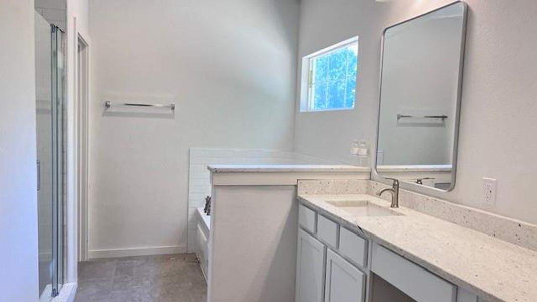 Bathroom with shower with separate bathtub and vanity