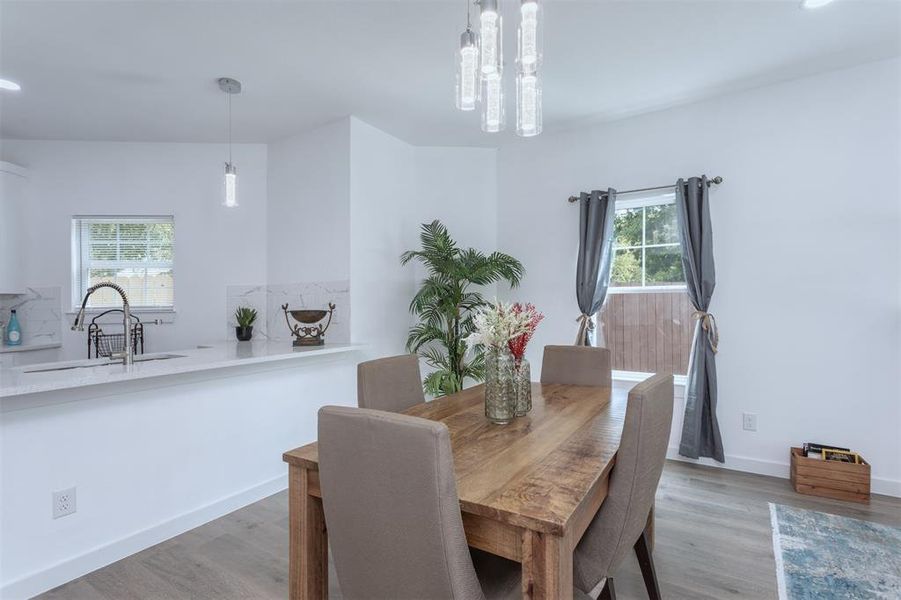 Dining room featuring light hardwood / wood-style flooring, a chandelier, and sink