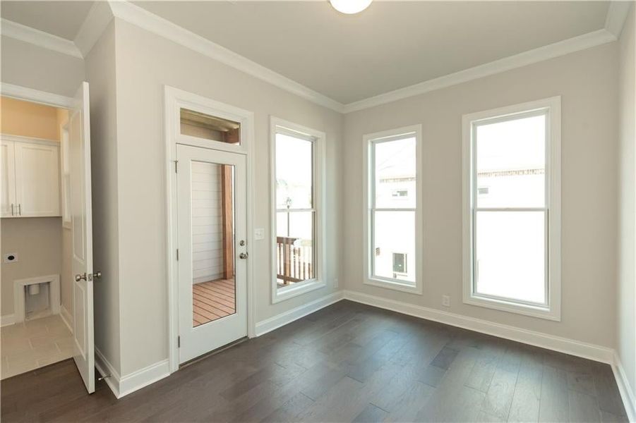 Behind kitchen is the sunroom! Perfect work from home space!