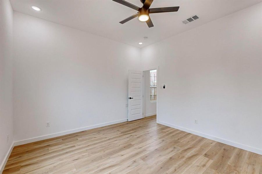 Unfurnished room featuring ceiling fan and light hardwood / wood-style flooring