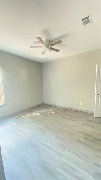 Unfurnished room featuring ceiling fan and hardwood / wood-style floors