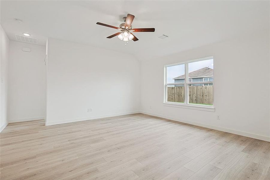 Unfurnished room with ceiling fan and light hardwood / wood-style flooring