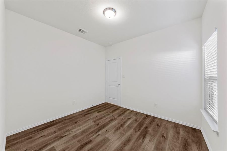 Unfurnished room with dark wood-type flooring