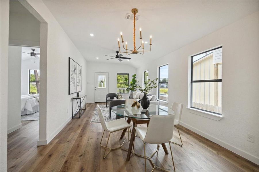 Enjoy good food and great conversation in this open, airy dining area with fantastic natural light and a bougie chandelier.