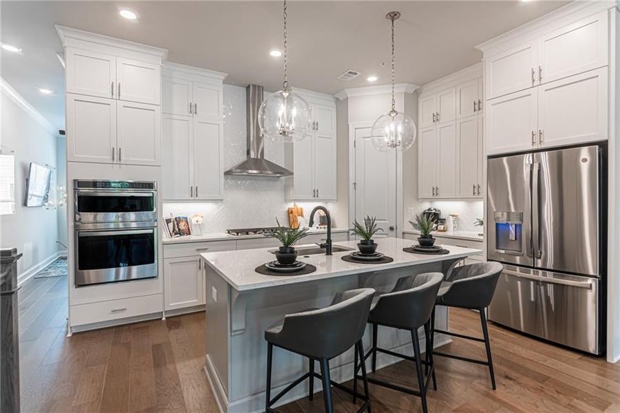 This wonderful kitchen island can hold 3 large bar stools, ideal for entertaining! Not actual home.