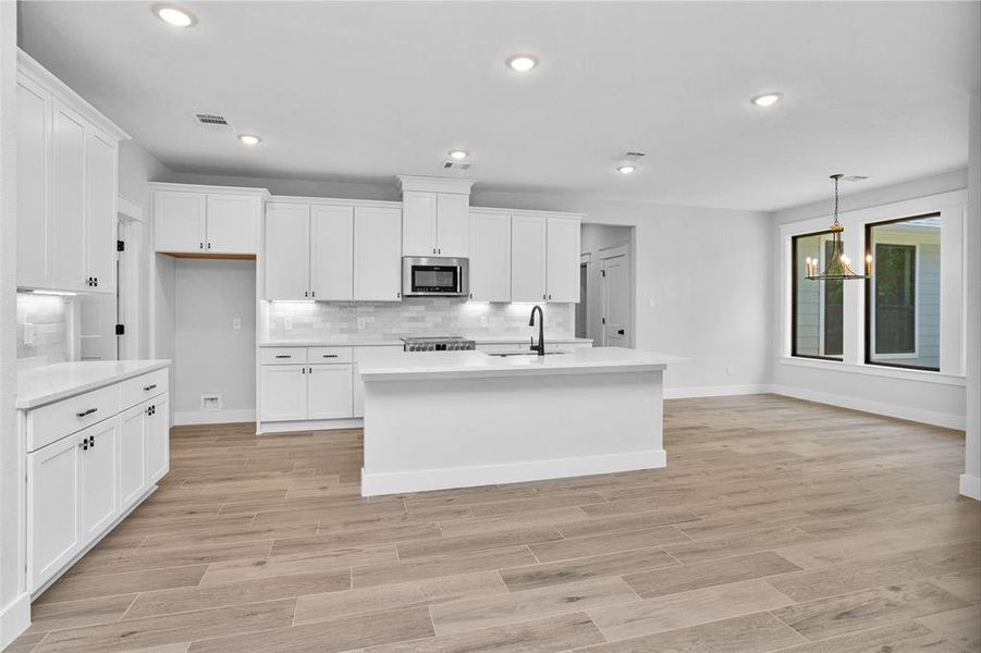 Bright welcoming kitchen with breakfast bar, quartz counter tops